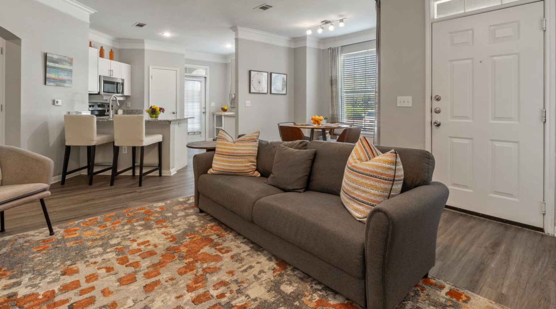 a living room with a couch and chairs