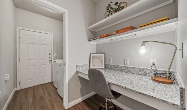 a white kitchen with a white countertop and a white door