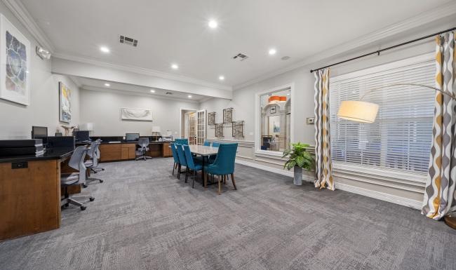 a room with a desk and chairs