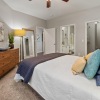 a bedroom with a bed and a fan