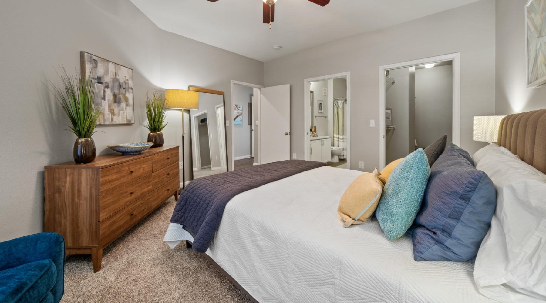 a bedroom with a bed and a fan