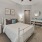 a bedroom with a bed and a fan