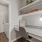 a white kitchen with a white countertop and a white door