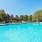 a swimming pool with trees and a building in the background